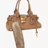 The Treasure Tails charm in shearling The Treasure Tails charm in shearling